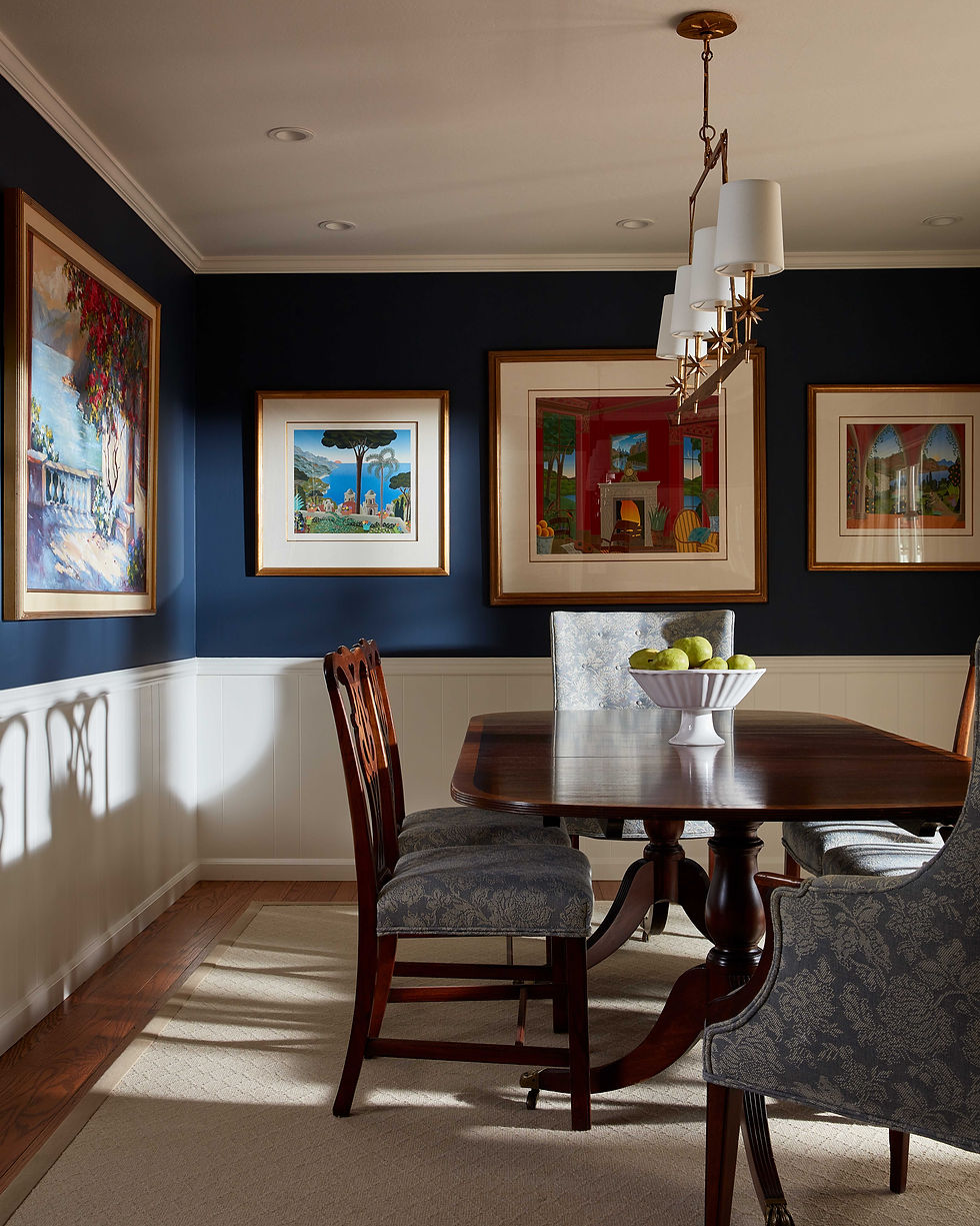 The homeowners beautiful art collection is beautifully highlighted when places on deep blue walls.