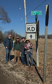 band Kinda Dead standing next to county highway KD in Southern Wisconsin.