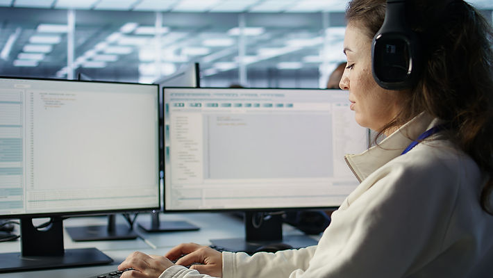 technician-wearing-headphones-inspecting-rackmounts-close-up.jpg