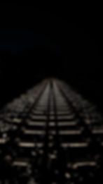 A picture of a railway track in the dark.