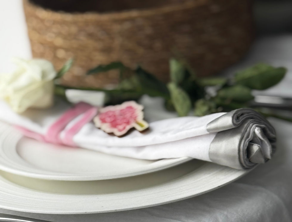 Hyacinth Wedding Favour with a pink ribbon tied onto a napkin set up for a wedding