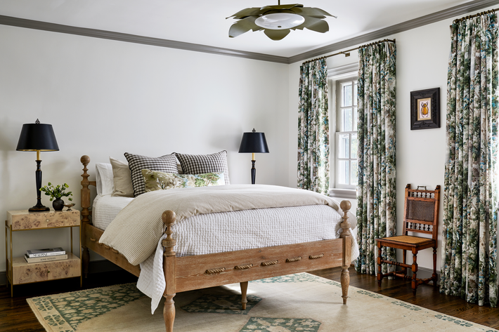 Bedroom with wood spindle bed and black lamps