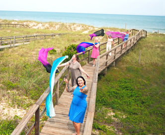 Sacred dance facilitator Anna Maria guides four women in intuitive movement on a private beach during the Soul Emergence Retreat in Kure Beach, NC.