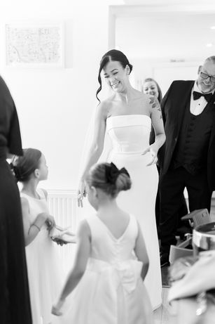 Bride greeting her bridemaids
