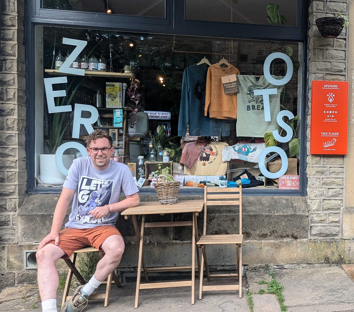 The owner of Otso Clothing sat outside his shop
