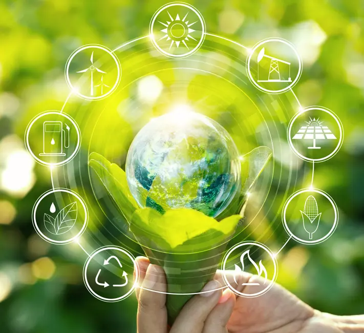 Hand holding Earth with green eco symbols.