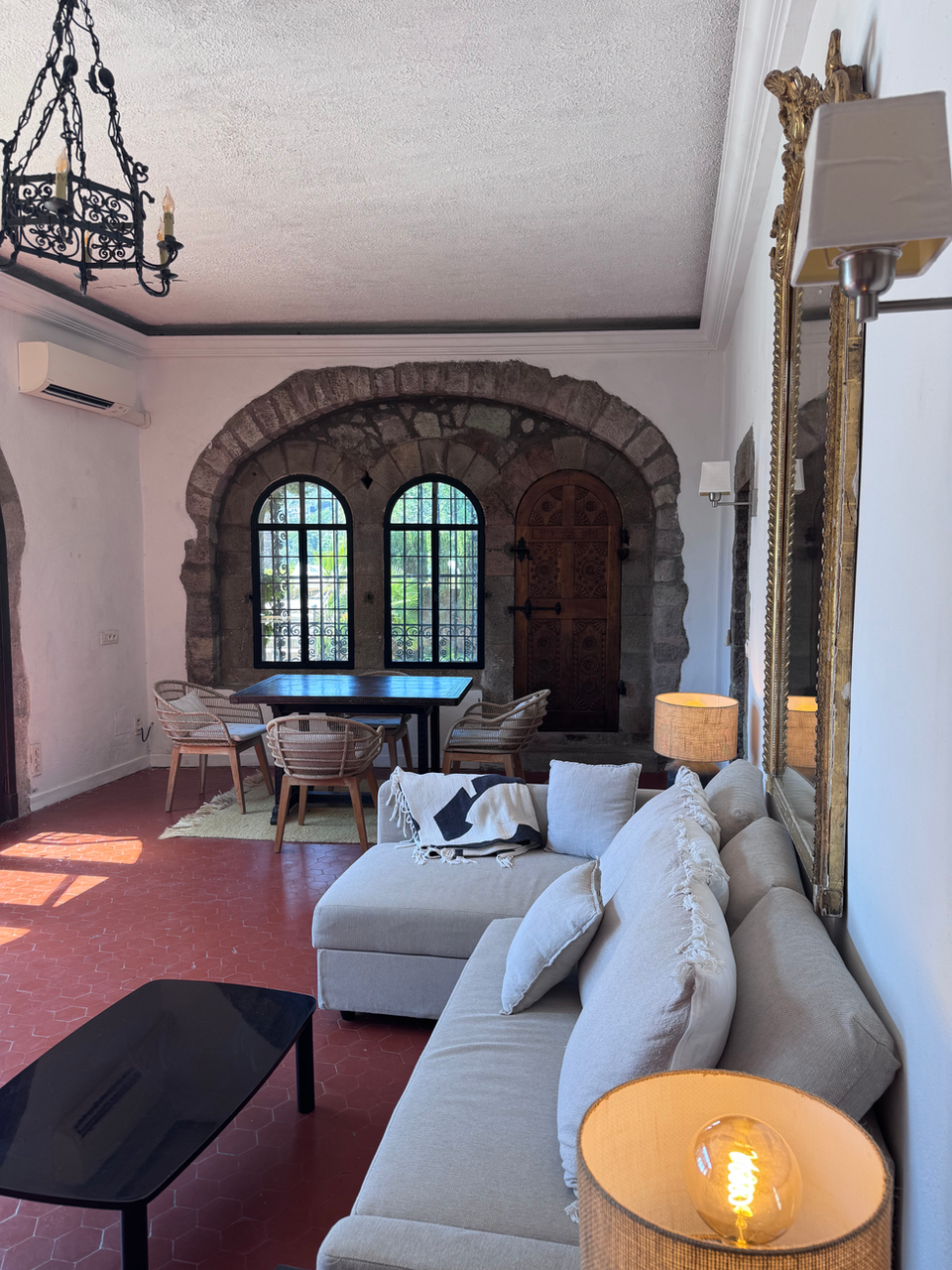 Rustic living room, L-shaped sofa, dining area, accommodations in south of France.