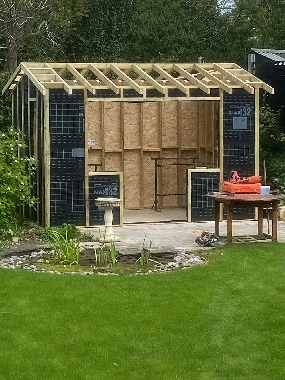 Wooden shed frame under construction, showcasing our work.