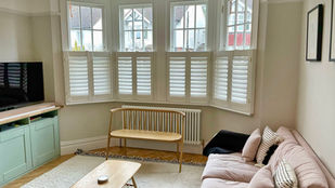 Cafe height shutters installed in a bay window in Harpenden