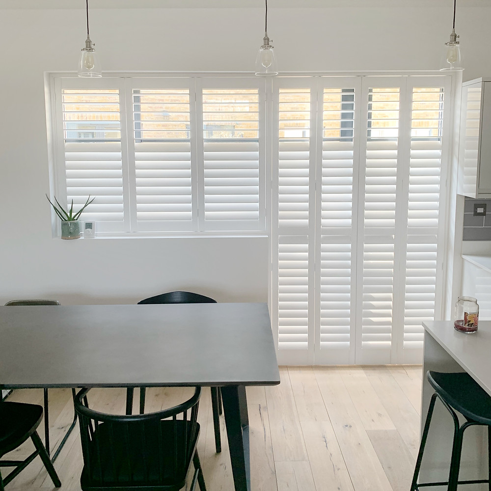 Full height white wooden window shutters