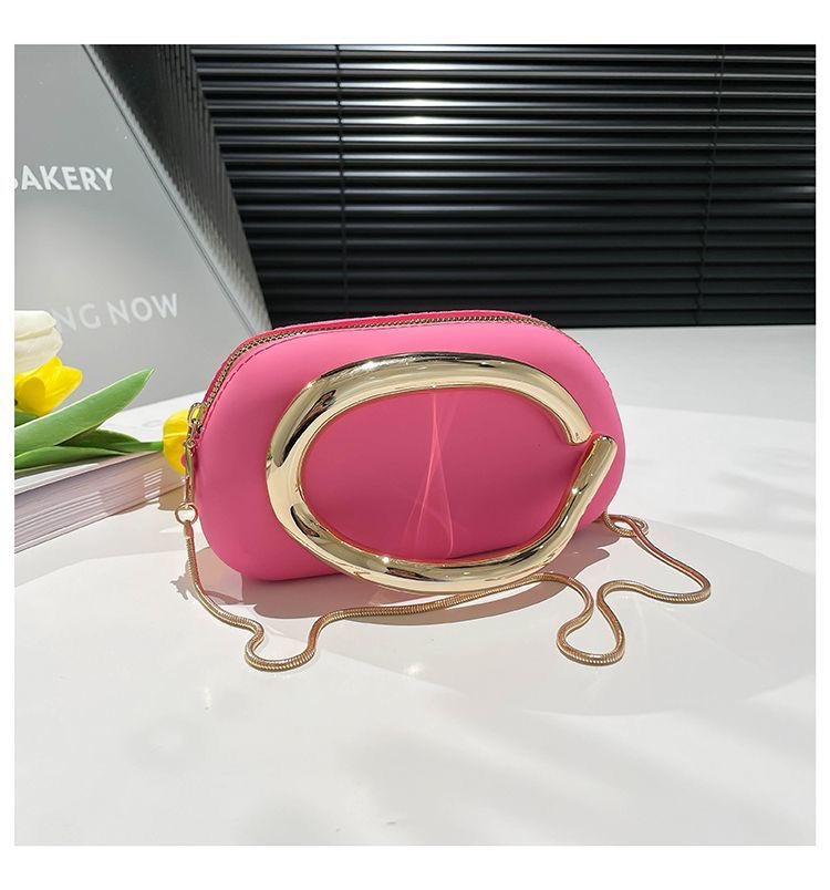 Small pink trendy cross bag with a gold chain strap