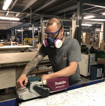 Skilled worker using a machine set in Wignalls Joinery workshops Newton Abbot, Devon.