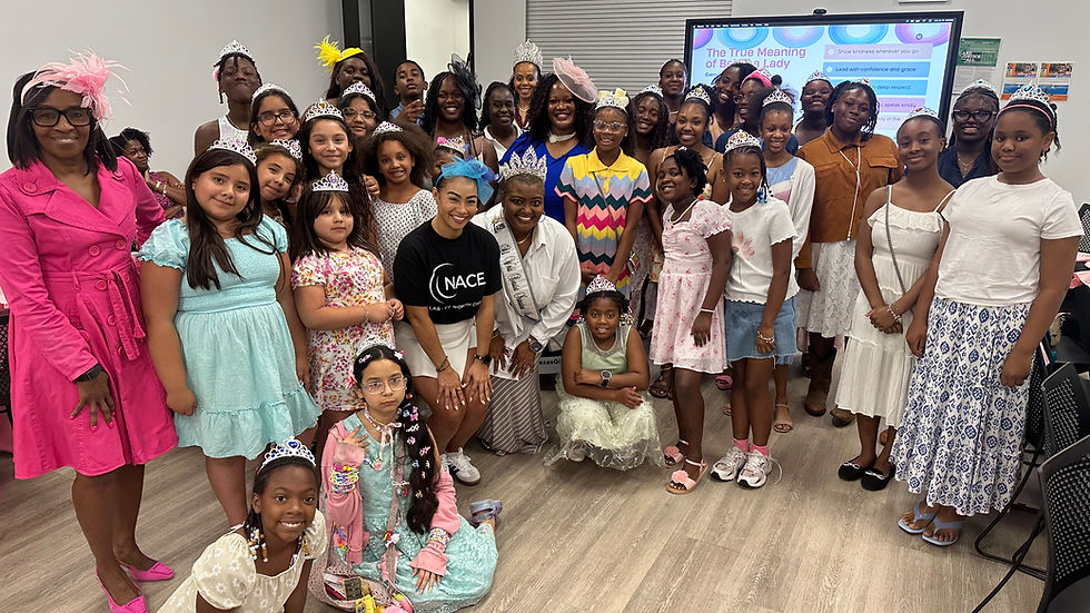 Wide angle view of the entire group of young ladies and volunteers gathered for a group photo