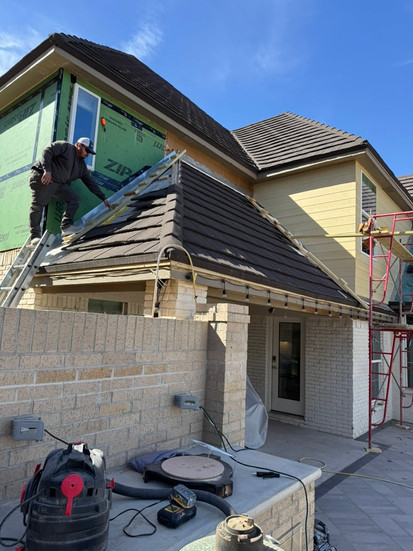 White Stag team installing zip system sheathing to second story of project home