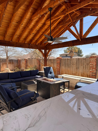 Outdoor kitchen view from counter and rock wall