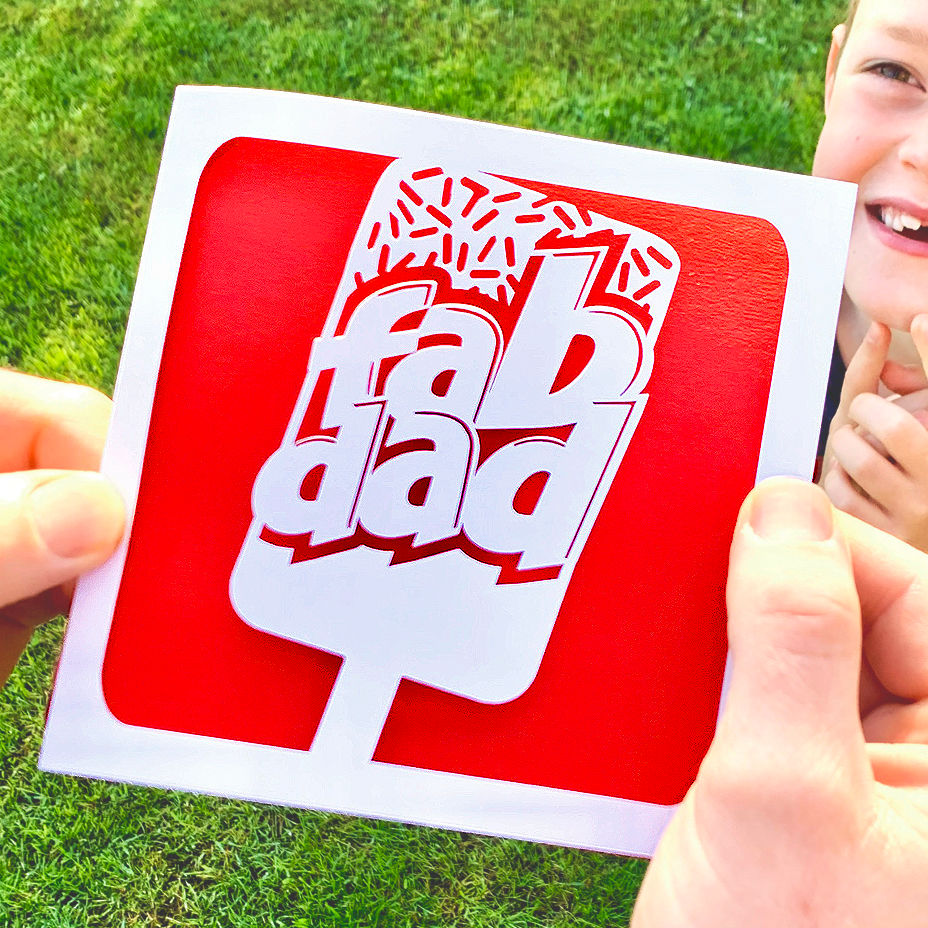 Thumbnail: White laser cut Father's Day card, with the silhouette of an ice lolly and the words 'fab dad', with a red paper insert.