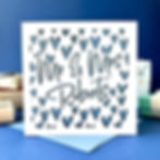 White laser cut wedding card, personalised with 'Mr & Mrs Roberts' and hearts pattern, with a blue paper insert.