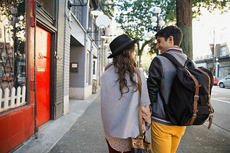Couple Walking on Urban Sidewalk