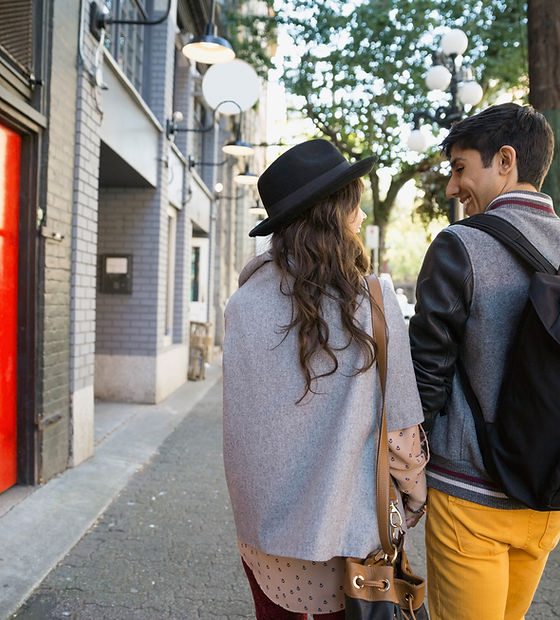 Couple-walking-on-urban-sidewalk