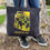 Thumbnail: Arizona State reusable black tote bag, iridescent howling coyote, red rock