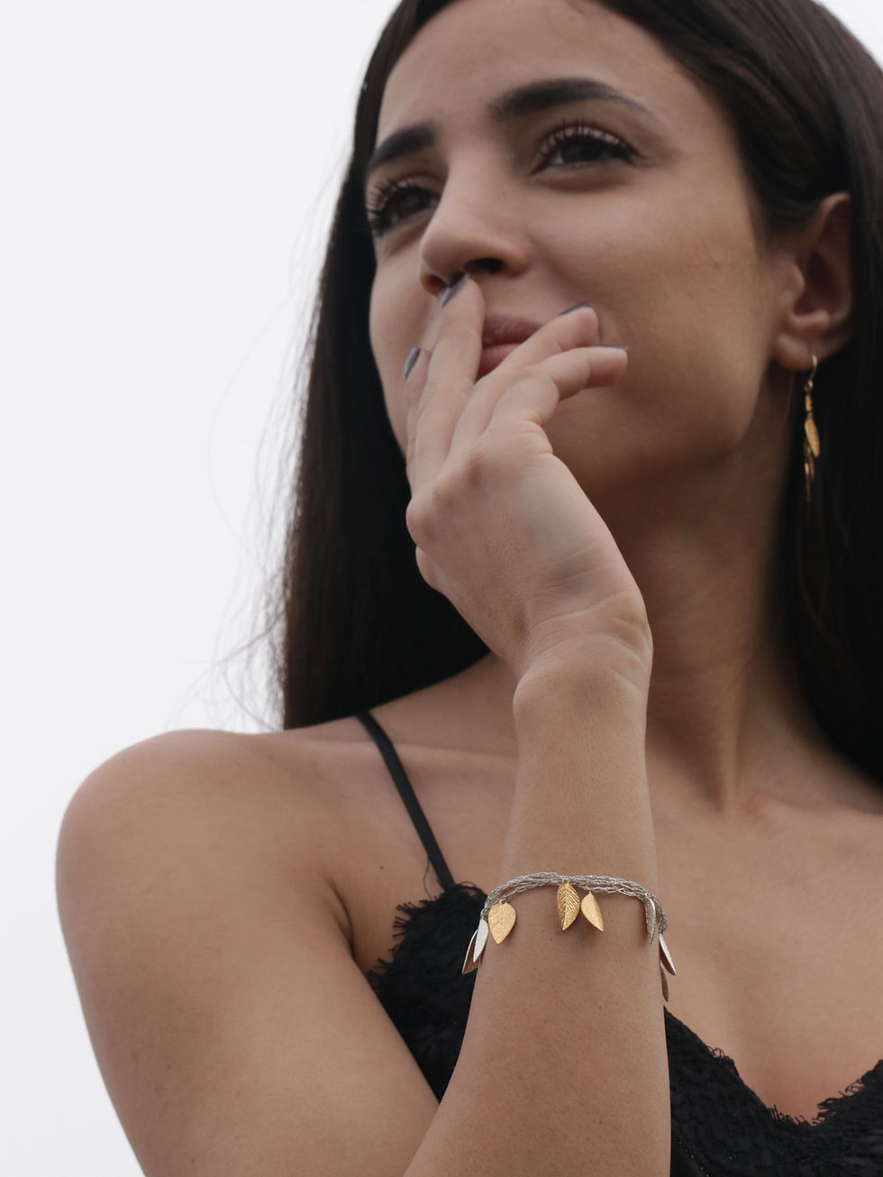 Thumbnail: A model wears a silk thread bracelet with gold and silver leaves 4