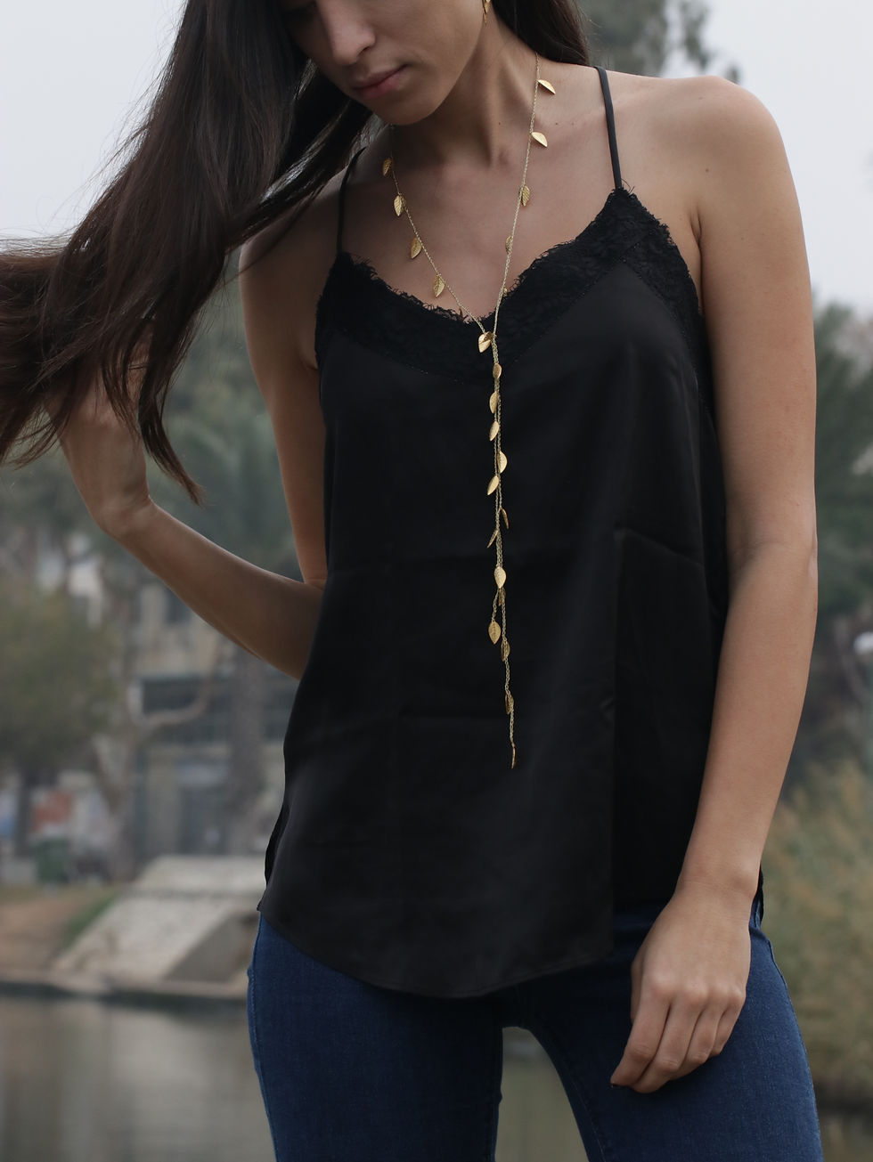 Thumbnail: A model wears a long silk necklace with gold leaves - photo 4