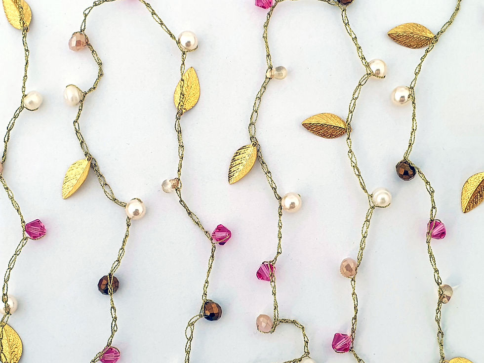 Thumbnail: gold silk thread necklace with leaves and pink crystals