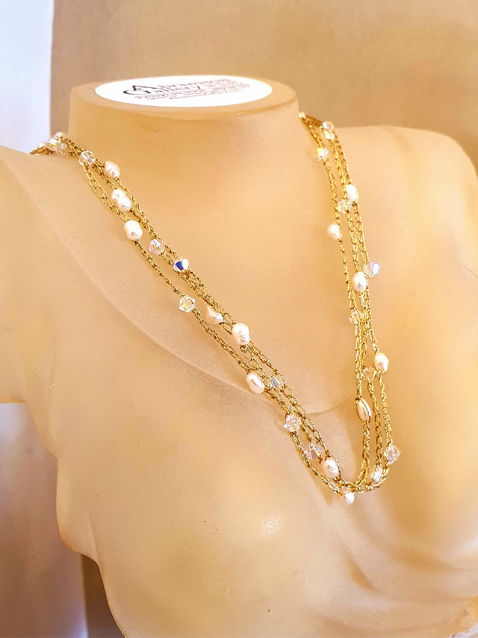 תמונה ממוזערת: Detail shot of the artisan crochet technique combining silk, pearls, and light-reflecting crystals