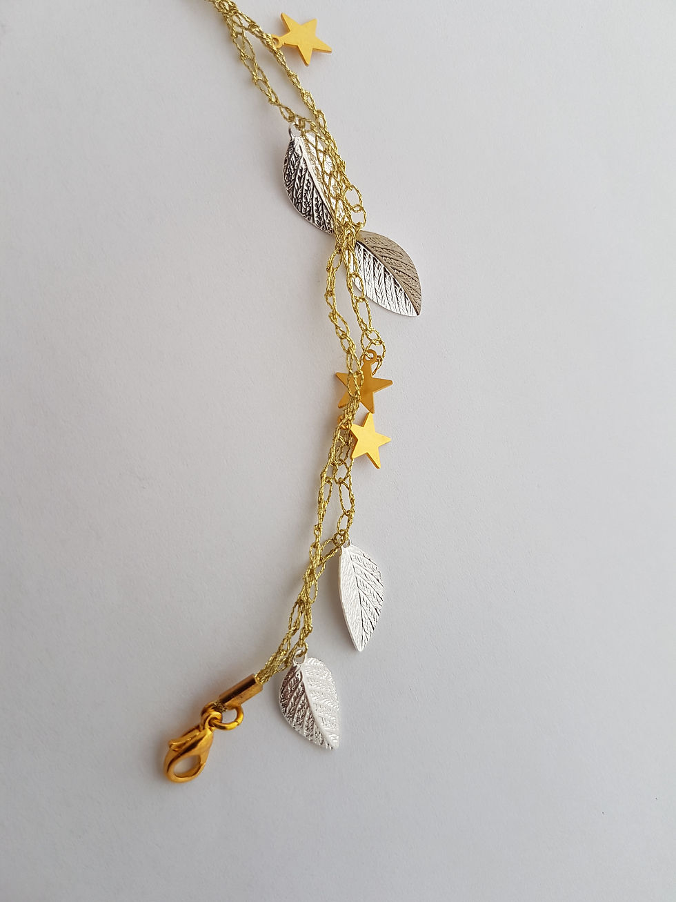 Thumbnail: Close-up handmade silk bracelet with leaves and stars by Abramson Gallery