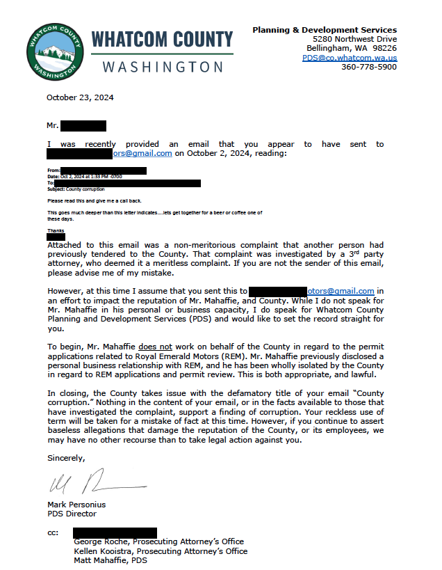 A formal letter from Whatcom County Planning & Development Services addresses a complaint, denying allegations and urging legal action caution.