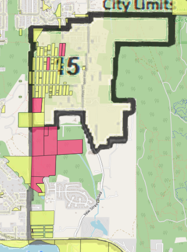 Map showing city limits with zones highlighted in yellow and pink. The number 5 is prominent. Streets and green park areas are visible.