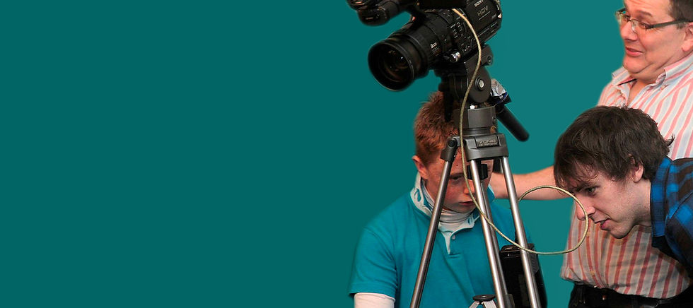 photo of three members of ABC looikng at a camera during a group project