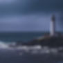 A lighthouse perched on a rocky coast