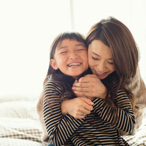 Woman and child hugging and smiling