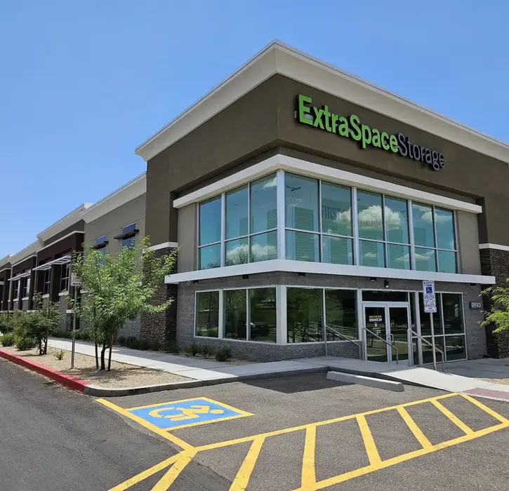 Exterior of an Extra Space Storage facility in Arizona, showcasing modern self-storage architecture with a two-story glass-front office and contemporary commercial design.