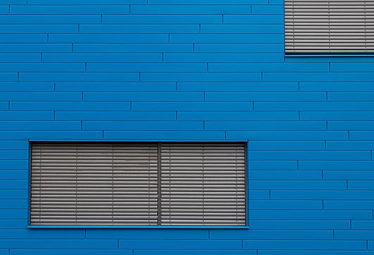 blue-brick-wall-with-grey-window-blinders.jpg