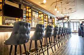 Row of bar stools at Liberty & Main restaurant in restaurant setting