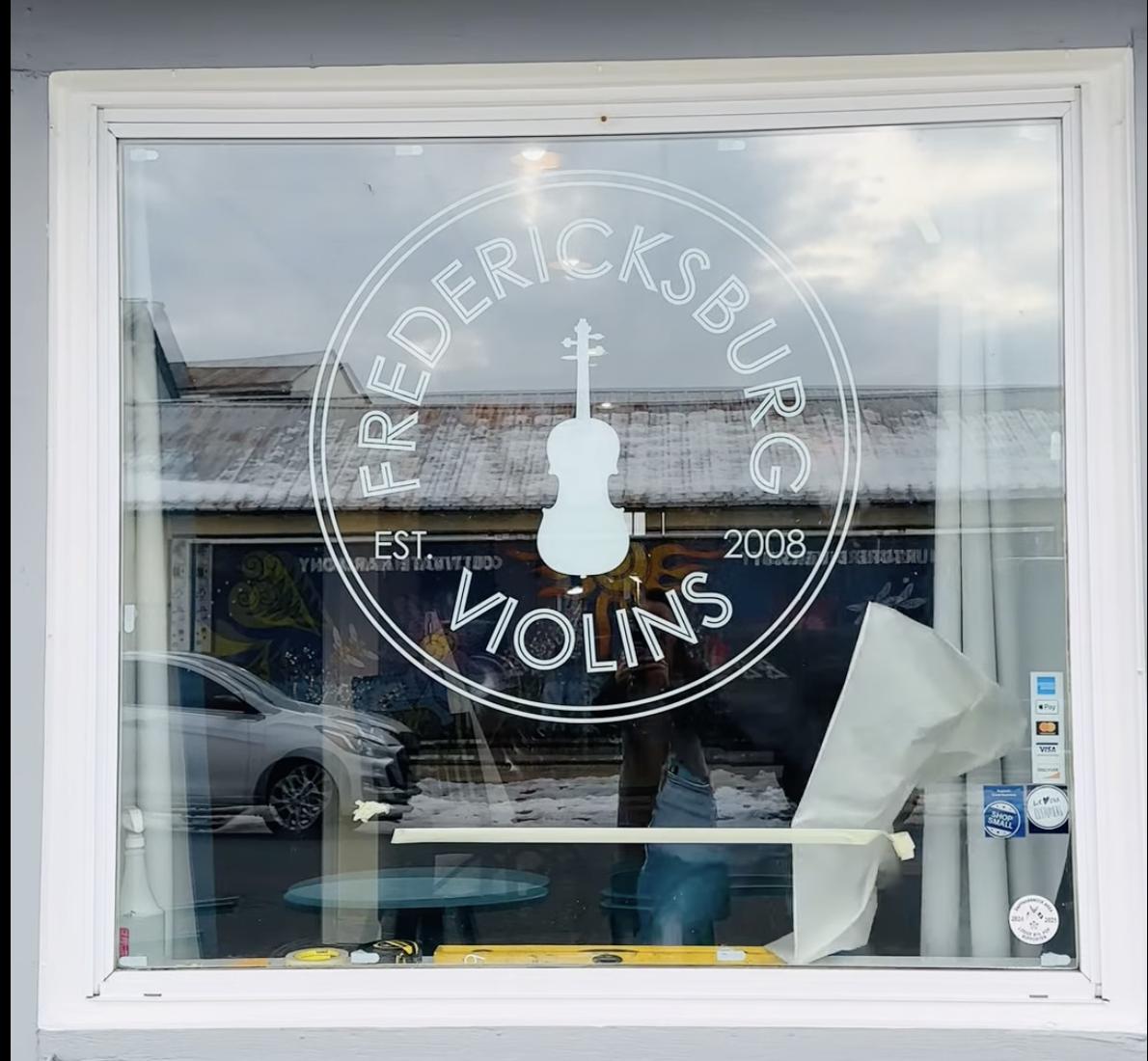 Fredericksburg Violin's window displaying their new logo which we helped to design.