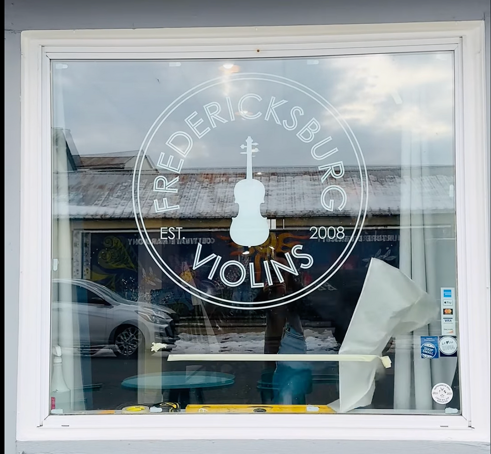 The front view of the Fredericksburg Violins shop, featuring their new logo.