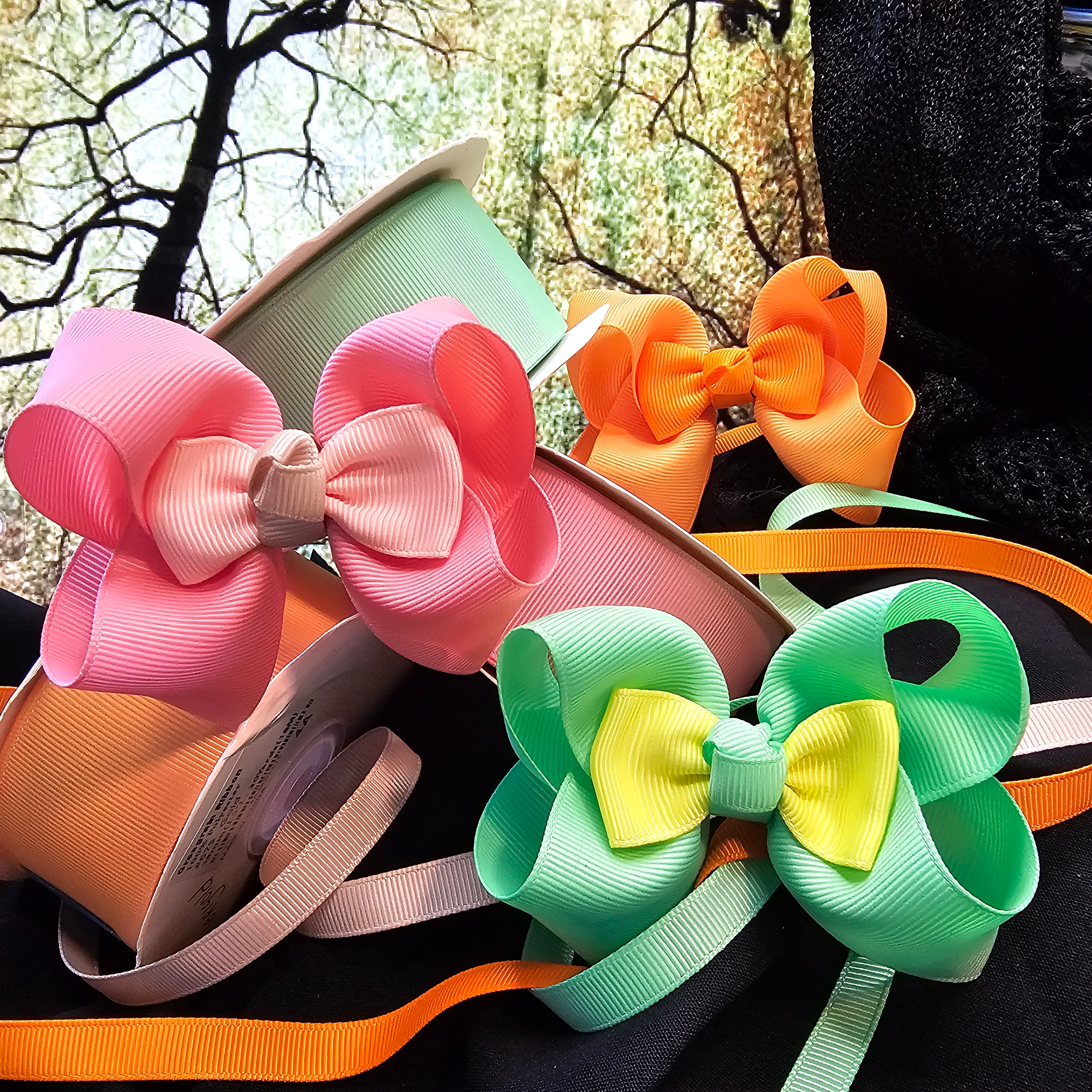 multiple color boutique hair bows yellow, red, blue, smaller bow in the center