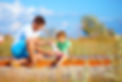 father bandaging injured leg of kid.jpg