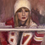 Thumbnail: Taylor Swift looking out a frosty window with Chiefs jersey and drink oriiginal