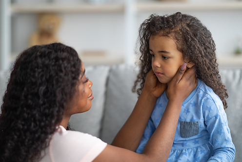 An adult speaks earnestly to a child, demonstrating trauma-informed discipline for fostering safety and growth.