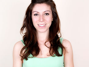 a woman with long brown hair smiling