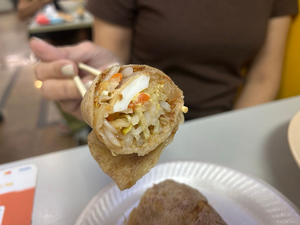 holding a piece of popiah