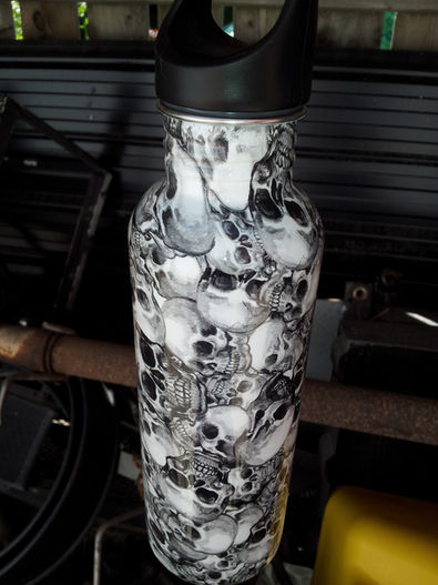 Hydrographic skulls on a white aluminum water bottle