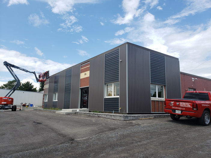 Charcoal and dark brown coloured steel siding on a commercial warehouse.