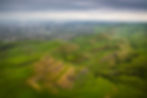 green hills near homes