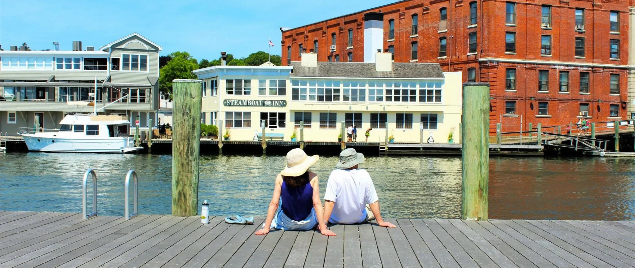 Mystic River with sailboats docked along the historic waterfront.