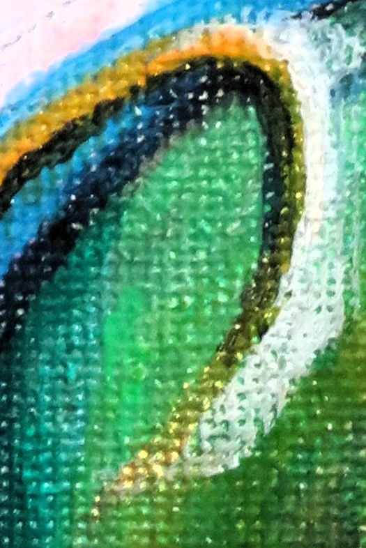 a close up of a colorful painting on a green canvas